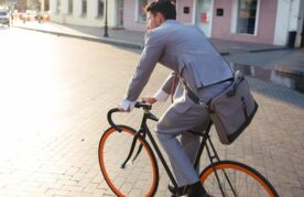 man in pak op de fiets